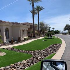 This beautiful front yard mixes artificial turf with xeriscaping